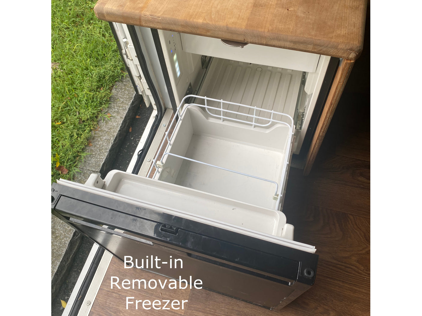 RV rental: This photo shows a built-in, pull-out freezer with a removable bin for convenient food storage.