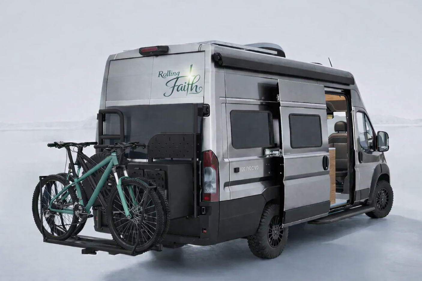 "Rolling Faith" custom camper van RV rental with bikes on back, side door open. Ideal for off-road travel and adventure.