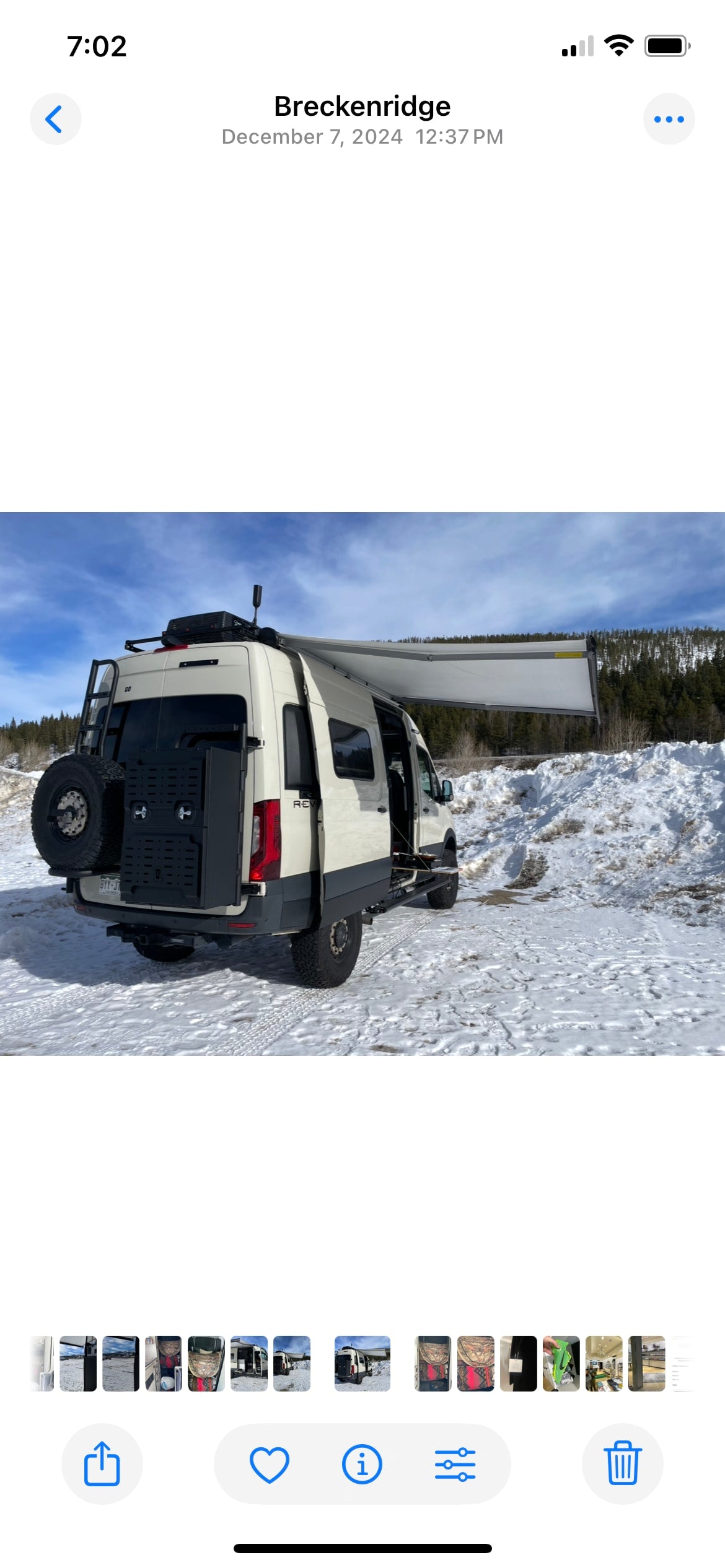 Adventure-ready rv rental parked in snowy Breckenridge, perfect for winter camping trips. Customized van with awning.