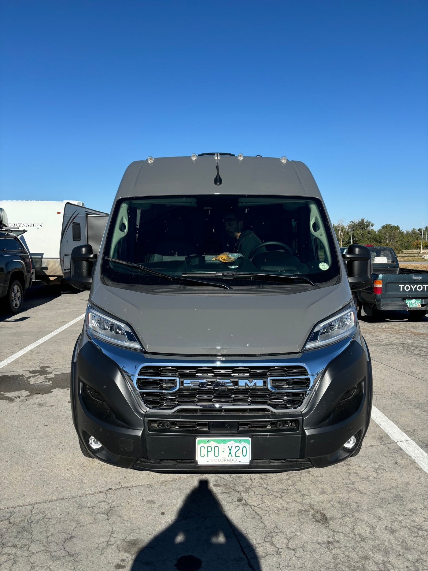 Gray Ram ProMaster camper van RV rental, parked under a clear sky. — photo 18
