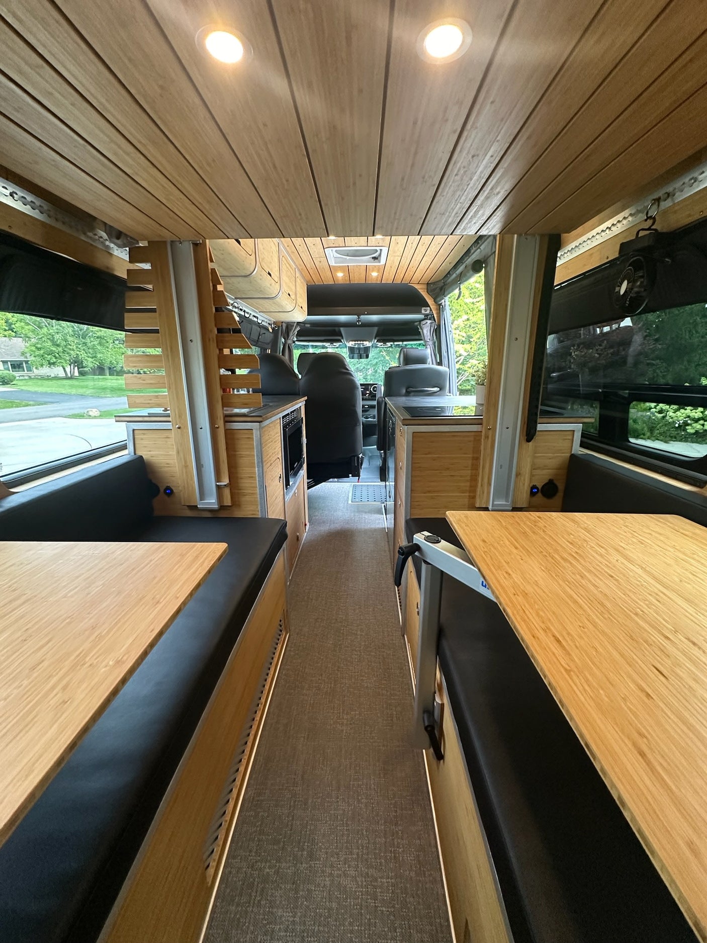 and integrated fridge drawers.|Modern RV rental interior with bamboo cabinetry