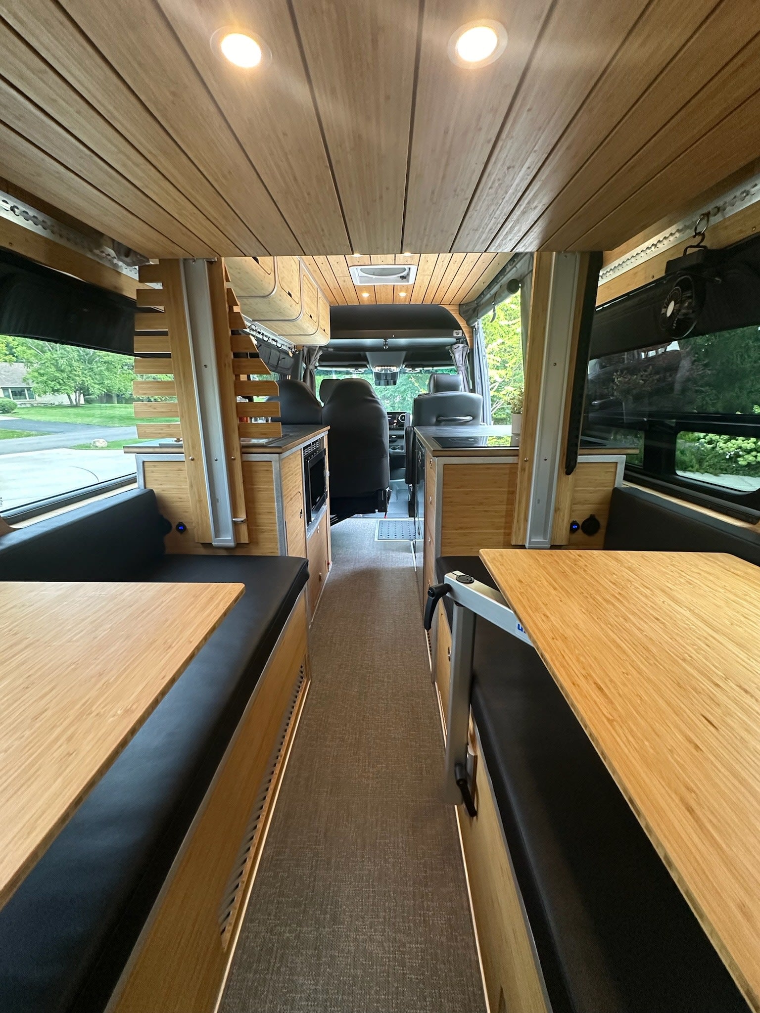 and integrated fridge drawers.|Modern RV rental interior with bamboo cabinetry