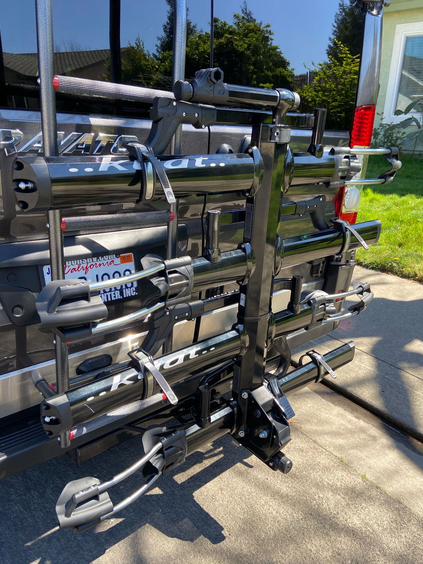 Rear of an RV rental with a black Kuat vertical bike rack, perfect for secure bicycle transport.