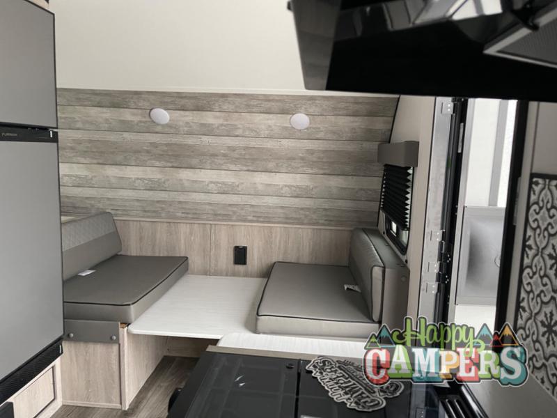 is ready for your rv rental camping adventure.|This white Intrepid compact travel trailer with green graphics is ready for your next RV rental adventure!|This white Intrepid travel trailer with green accents