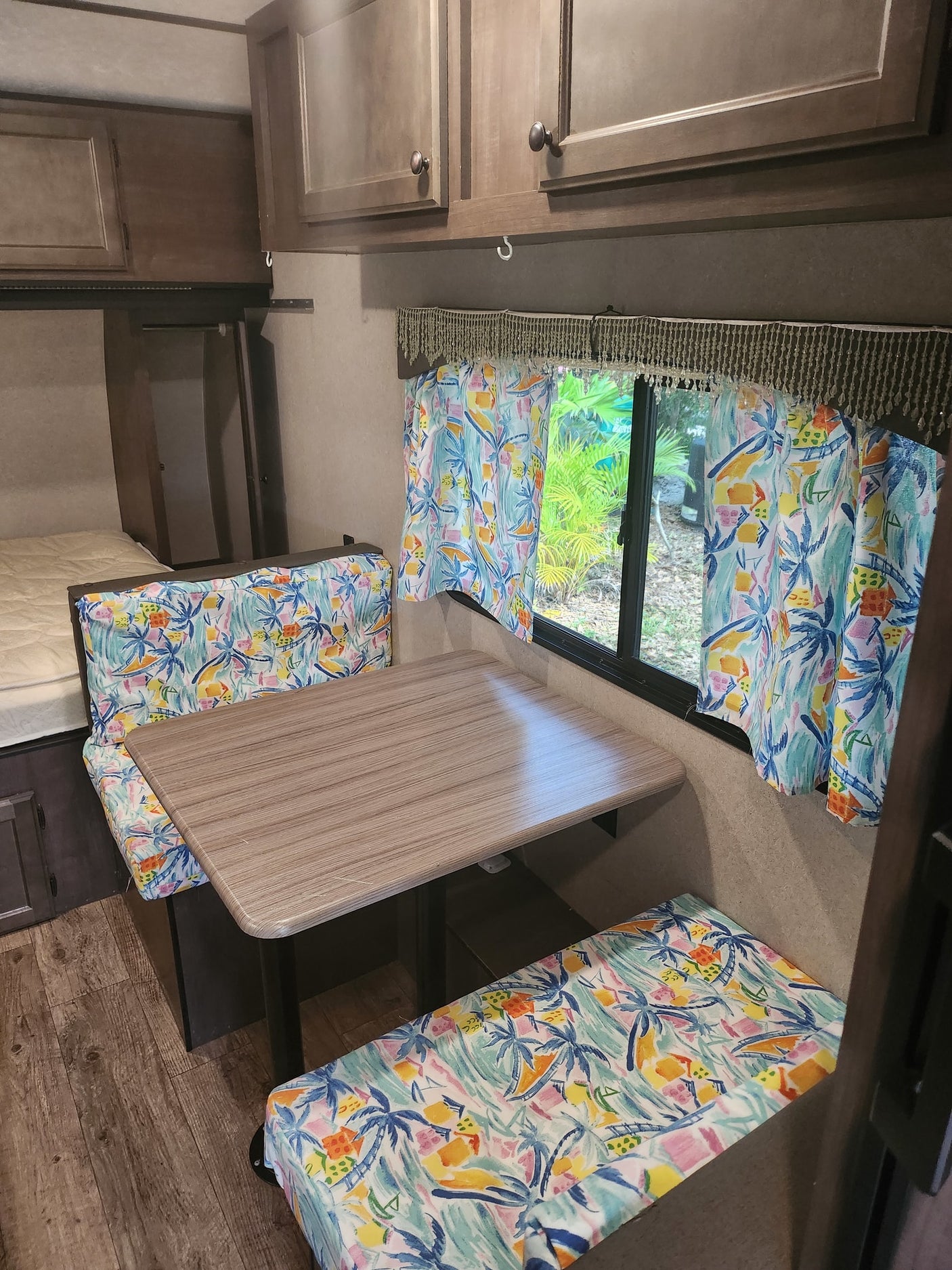 and faux stone backsplash with a window view.|RV rental kitchen: Compact space featuring a modern stove