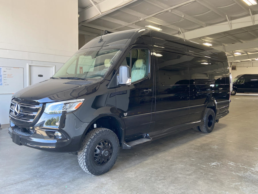 sunny day with people.|Step into luxury! This RV rental boasts a spacious custom interior with plush cream seating