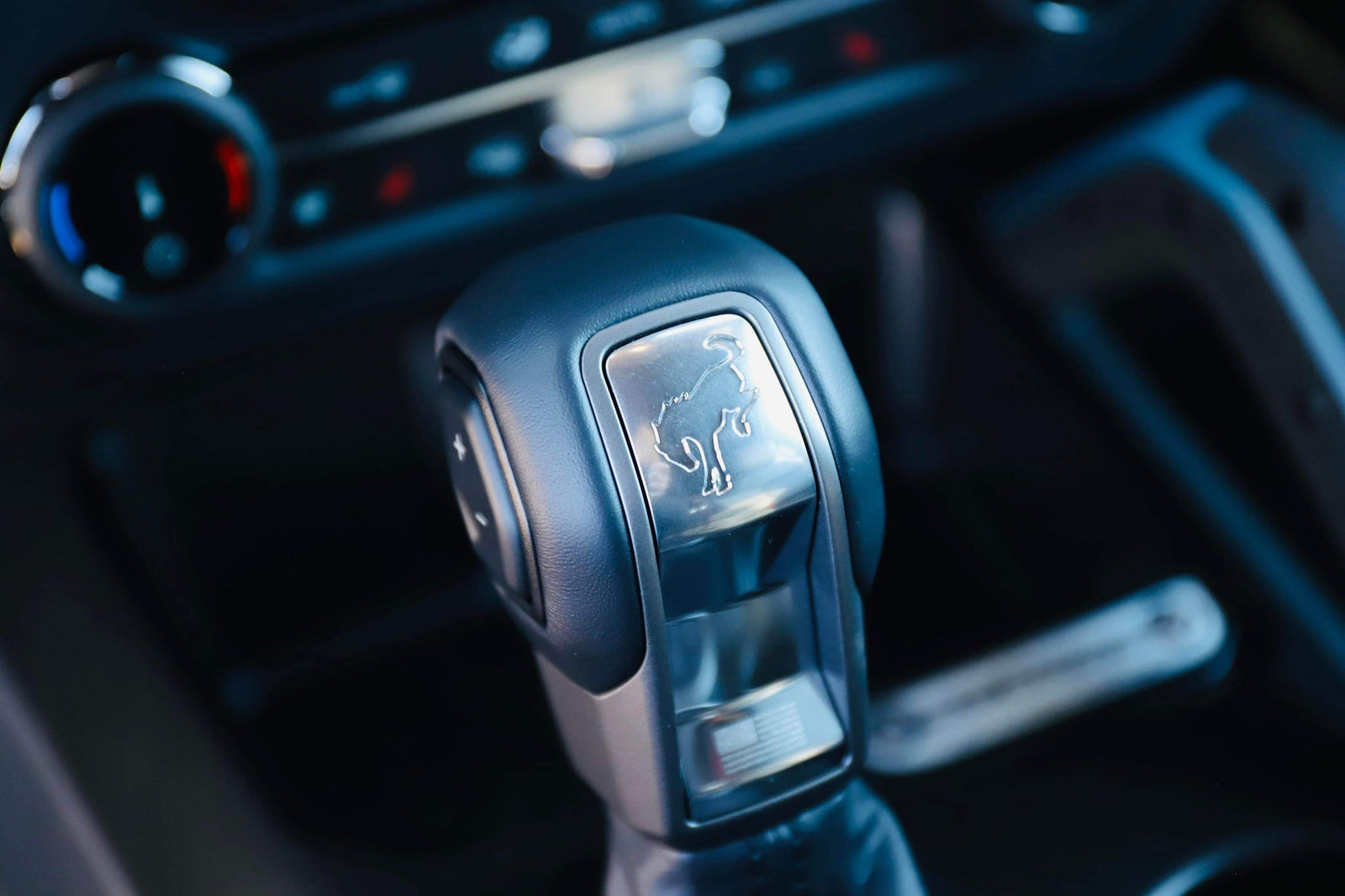 Close-up of a vehicle's automatic gear shifter with a Ford Bronco logo. Essential interior detail for your next rv rental.