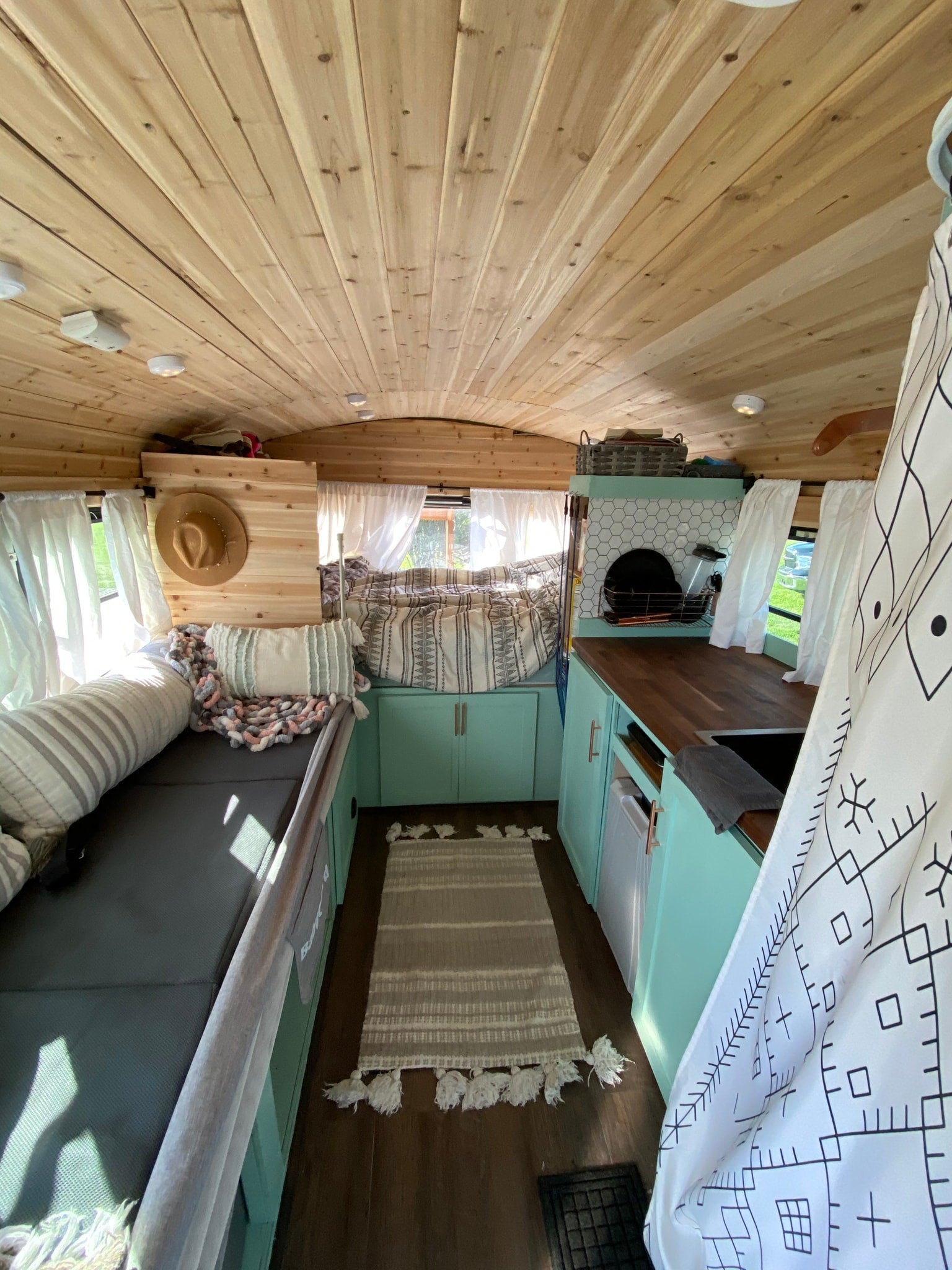 parked among tall pine trees. Perfect for a nature adventure.|Explore this RV rental's cozy