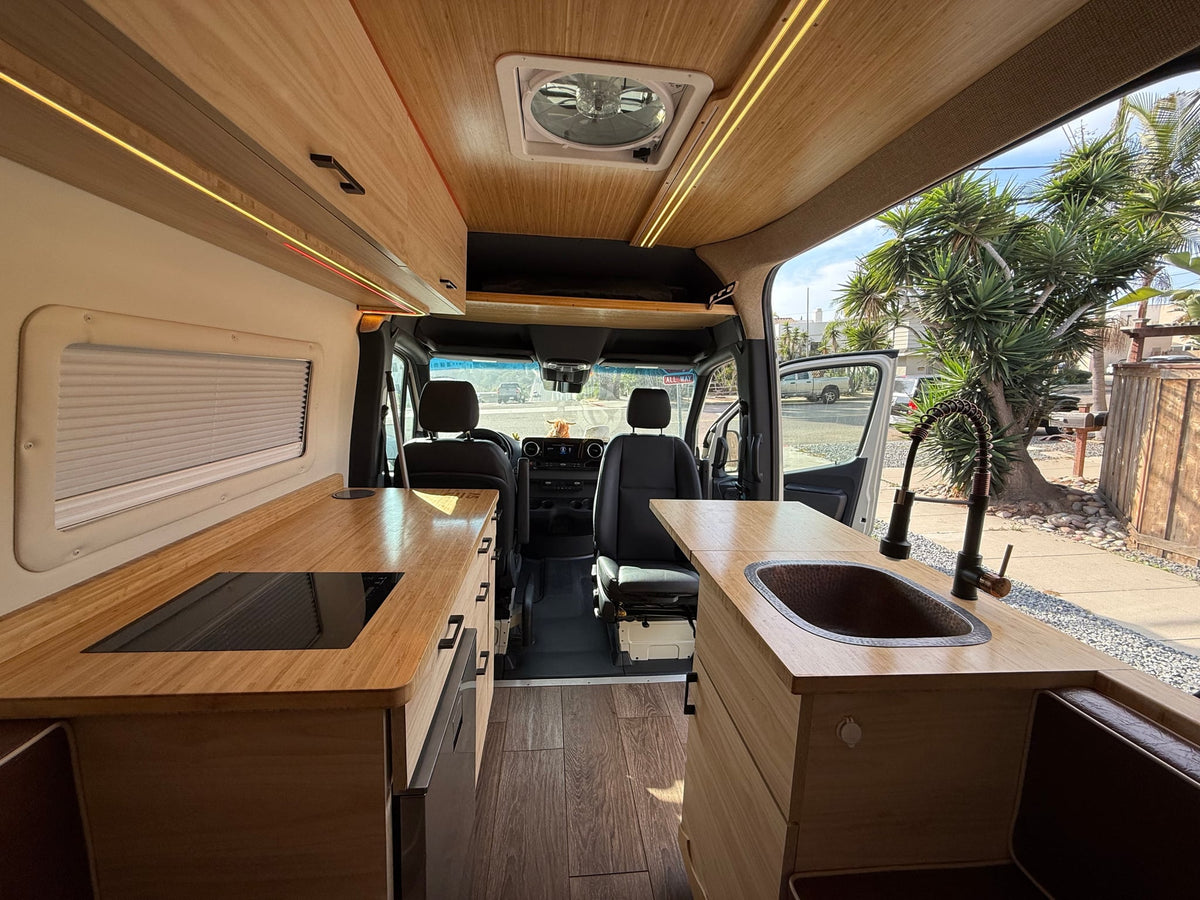 This RV rental's inviting interior features light wood kitchen counters — photo 1
