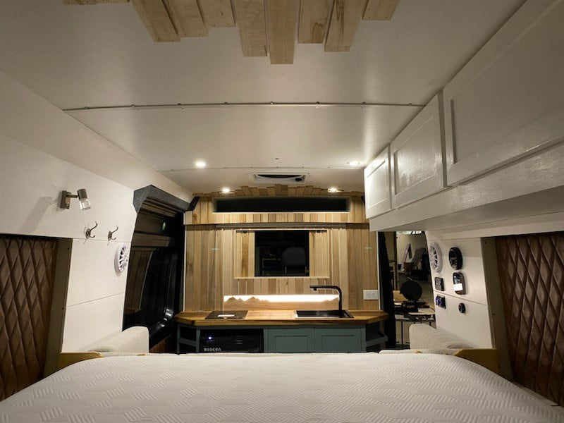 and cozy seating. Ready for adventure!|Modern RV rental conversion: L-shaped sofa