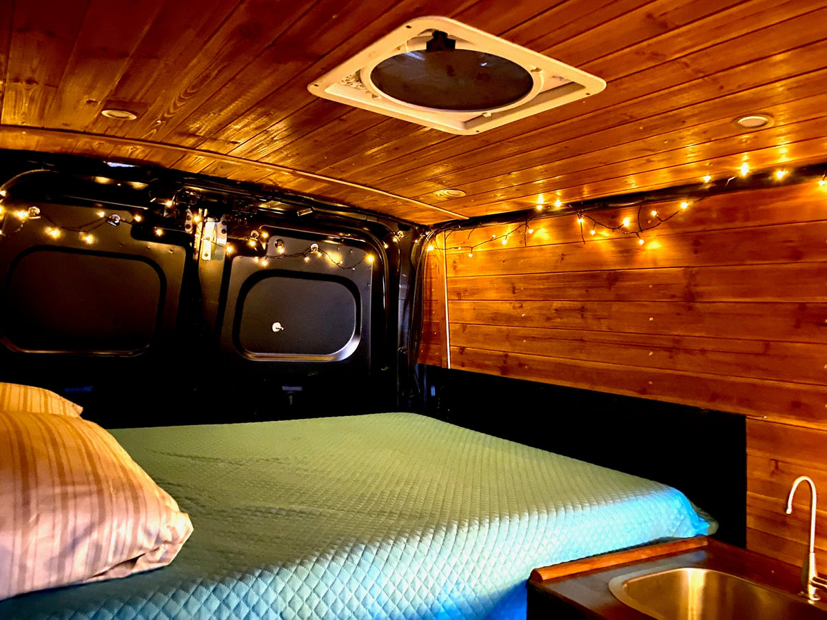 with marina and boats outside.|Explore our cozy RV rental! Features a comfy bed — photo 2