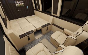 facing a beach landscape. Perfect for rv rental.|Inside a premium RV rental: spacious interior with plush cream captain's chairs