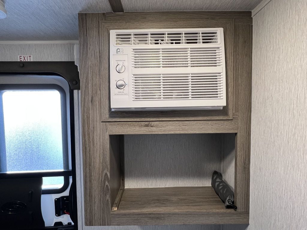 and controls for your trip.|Black outdoor shower access panel with keyhole on an RV rental.|Outdoor kitchen in an RV rental featuring a stove