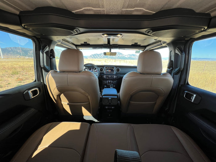 Inside a Jeep SUV, ready for your RV rental adventure. Tan leather seats, spacious interior, & scenic mountain views.