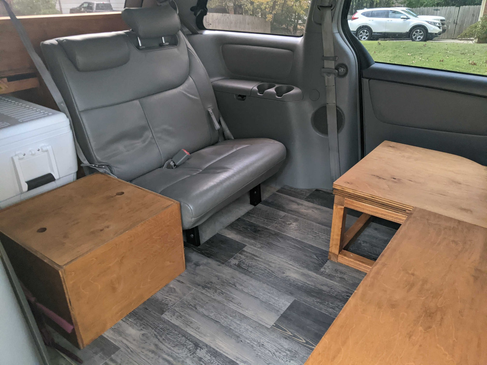 surrounded by trees.|Woman prepares food in a custom RV rental kitchen