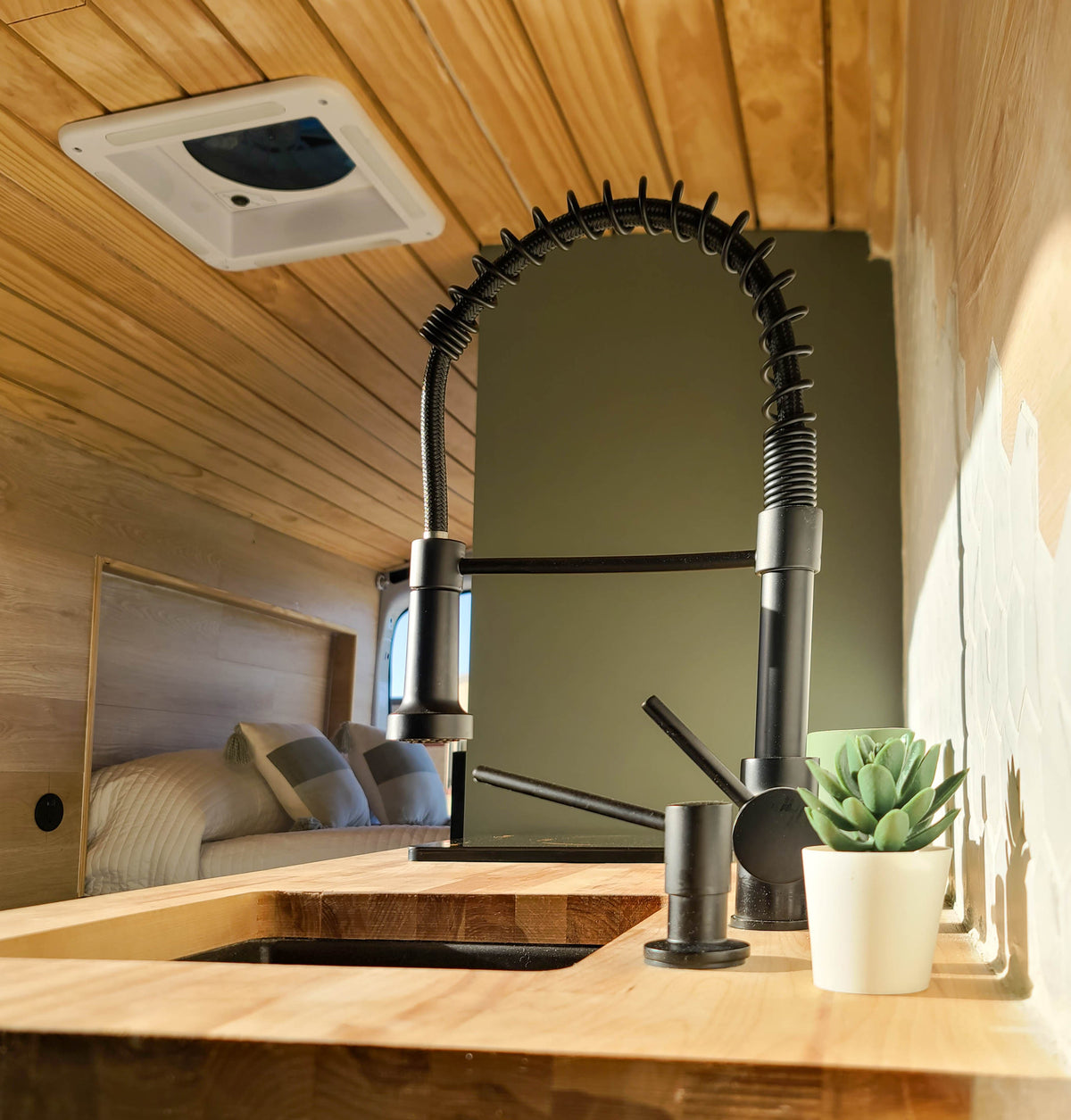 & green cabinets.|Cozy RV rental interior with custom wood walls