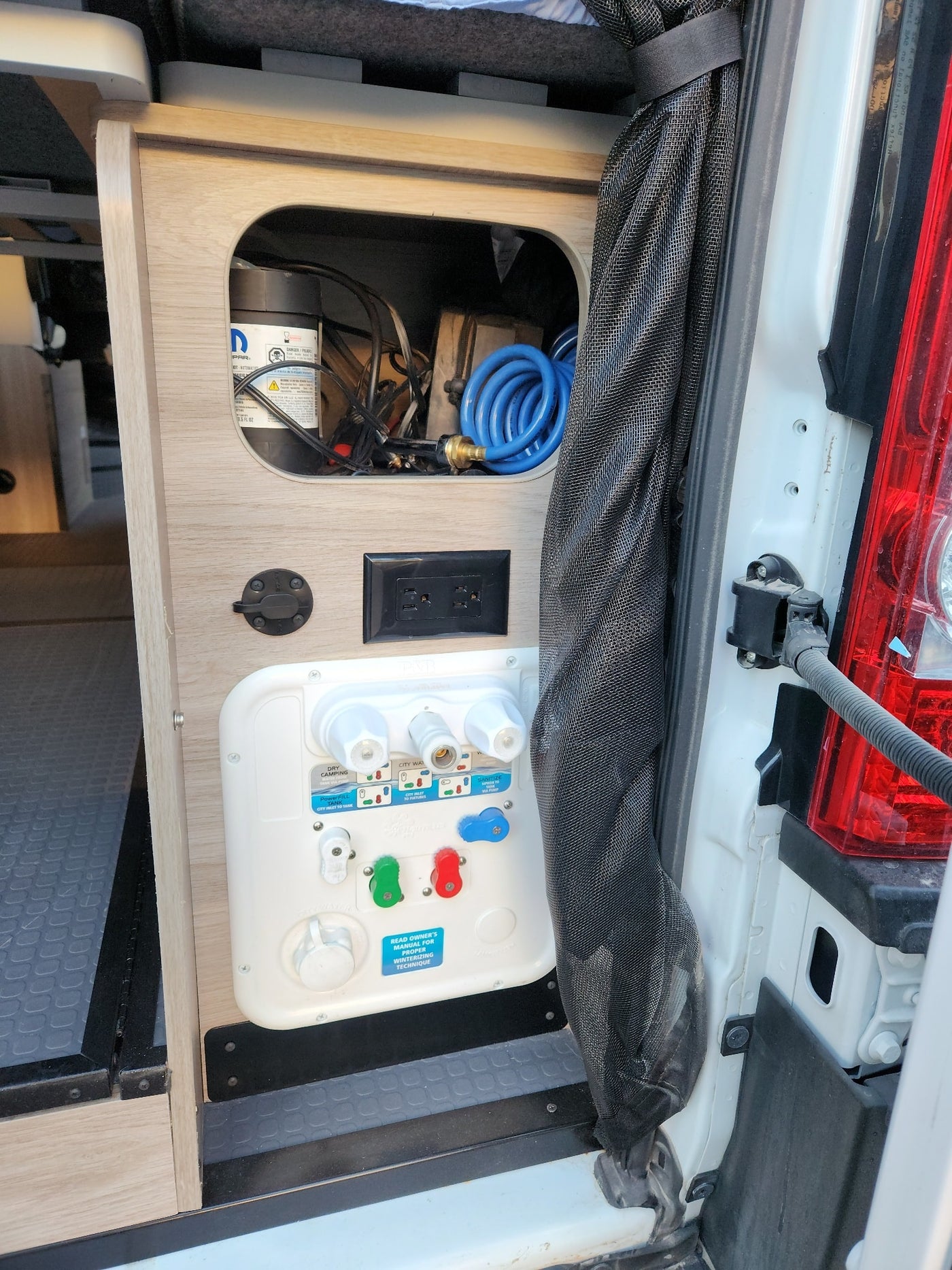 and controls for comfy travel.|Inside an RV rental pop-top camper: plastic-covered bed — photo 17