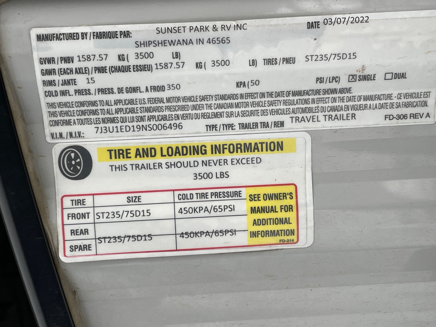 RV rental trailer info label shows VIN, tire size ST235/75D15, cold pressure 65PSI, and 3500 lbs load capacity.