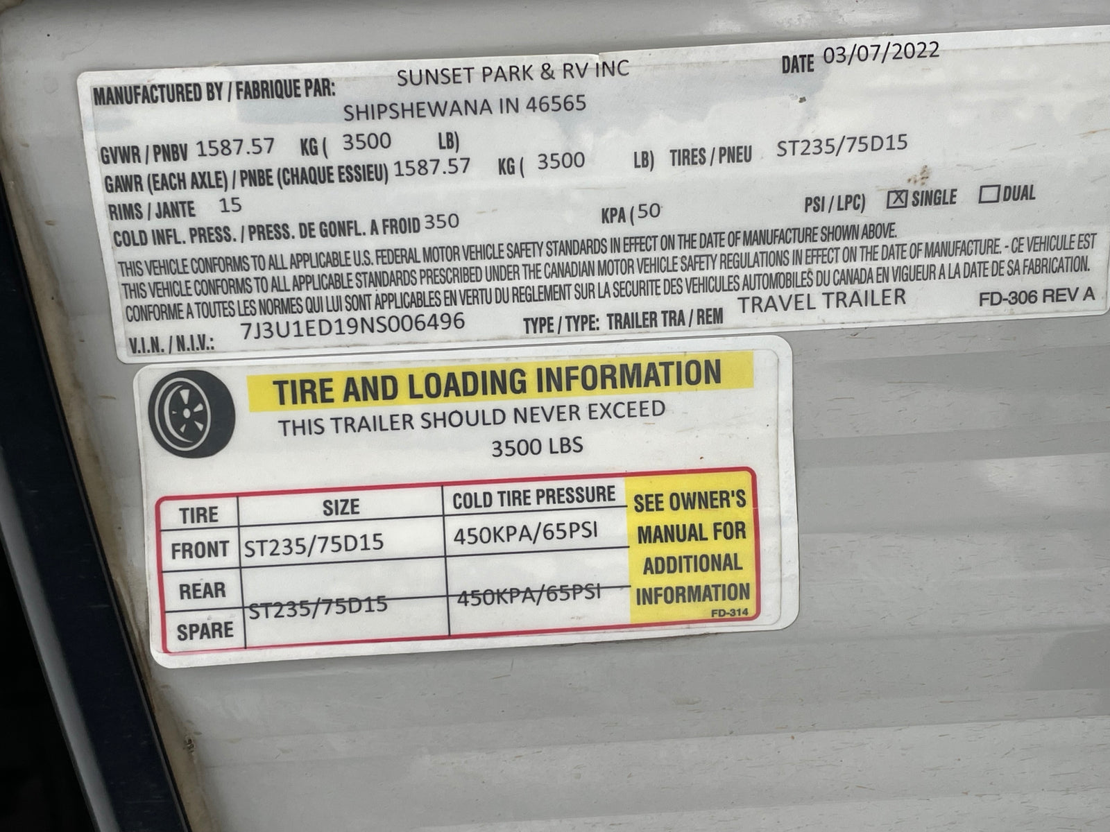 RV rental trailer info label shows VIN, tire size ST235/75D15, cold pressure 65PSI, and 3500 lbs load capacity.