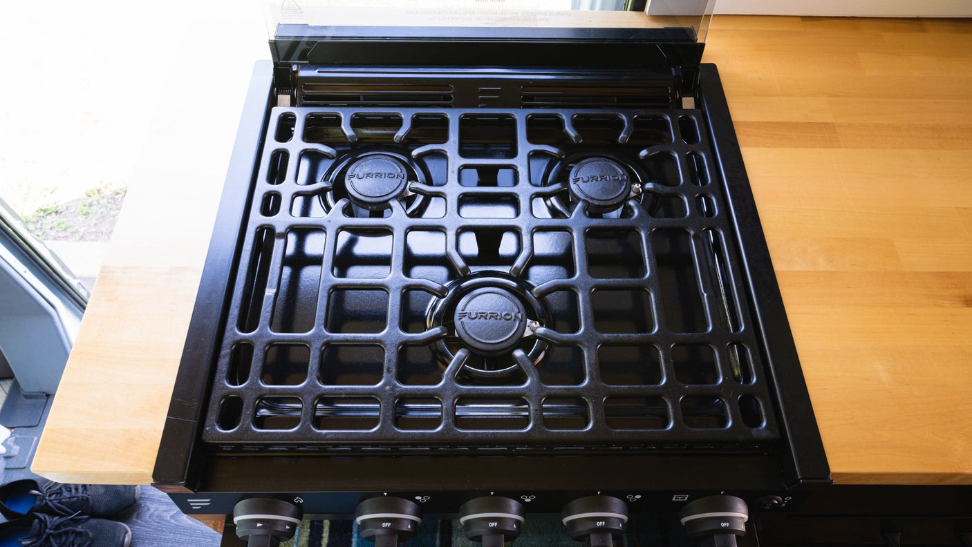 on an RV rental vehicle side.|This RV rental interior features blue cabinetry with an outlet