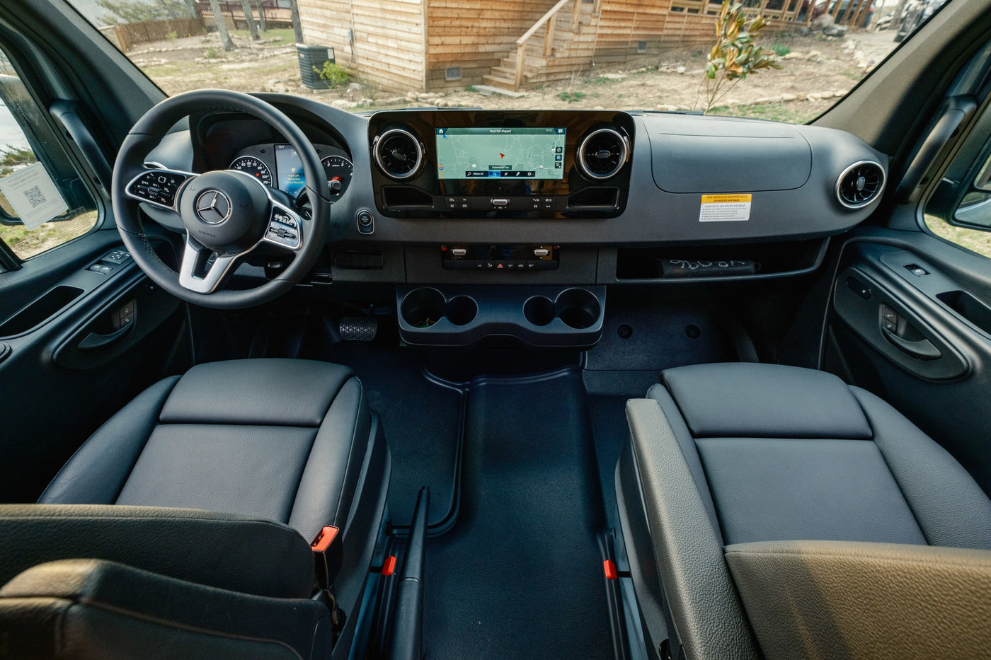 RV rental: Modern Mercedes Sprinter interior with navigation, dashboard, and spacious seating. — photo 15