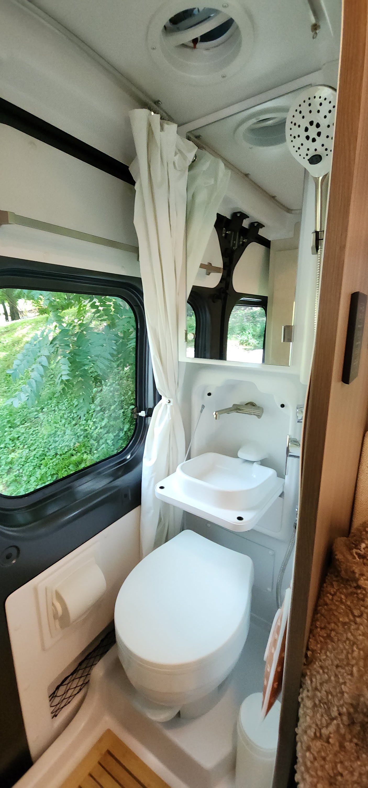 RV rental bathroom: compact design with toilet, foldable sink,