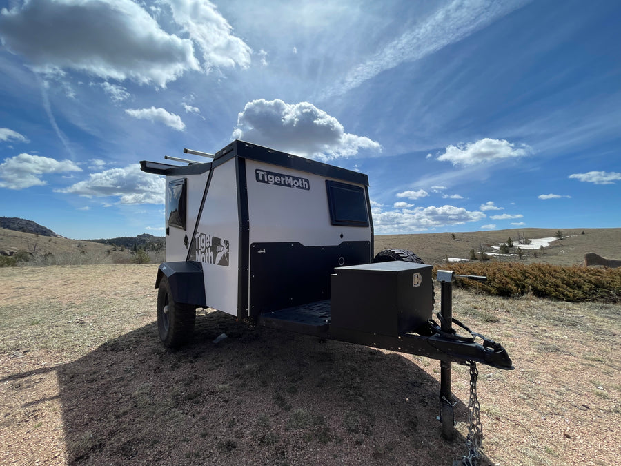 This overland TigerMoth camper trailer is perfect for your next rv rental adventure, parked amidst nature.