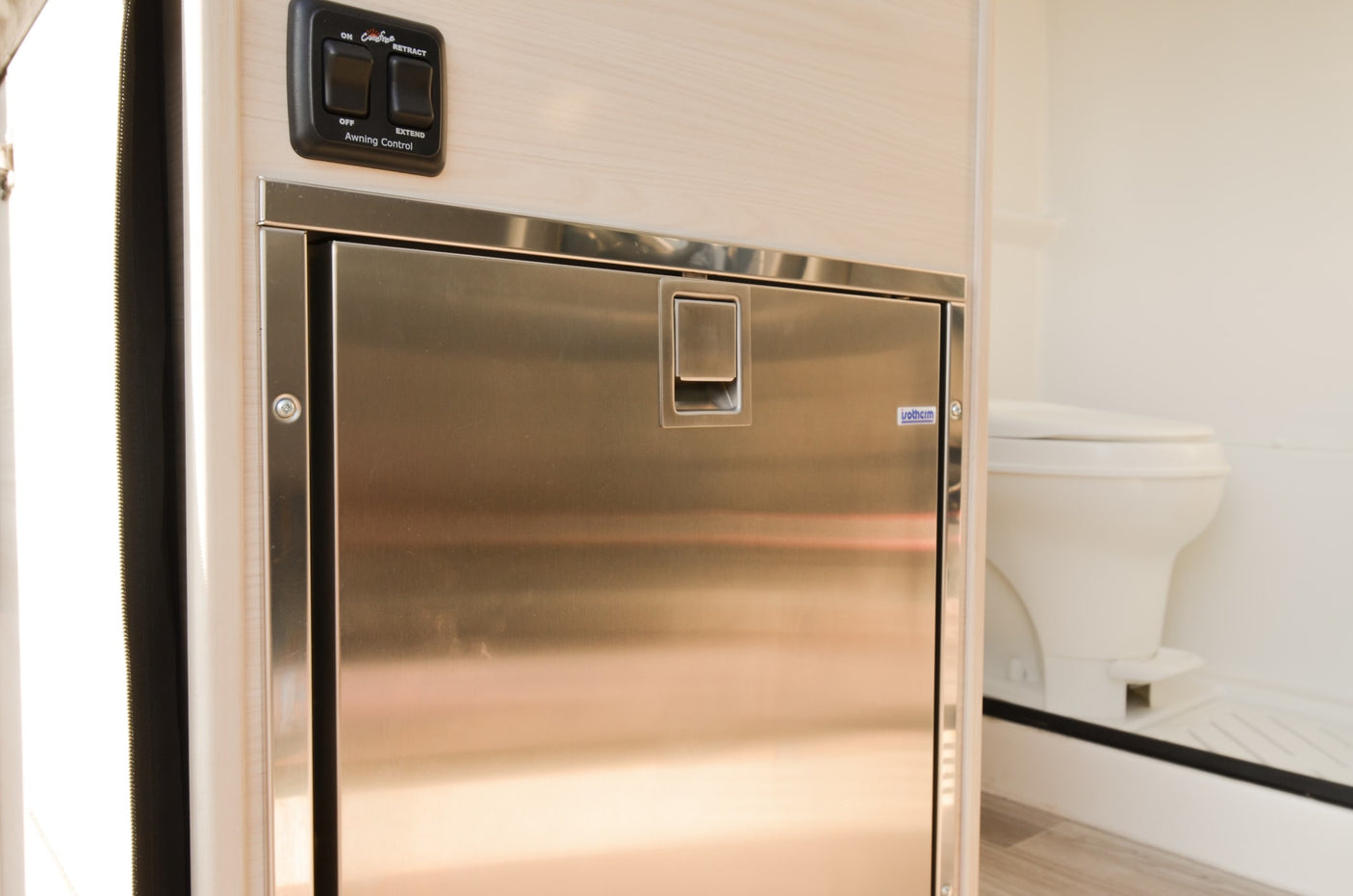 and scenic outdoor views through large windows.|View of a modern rv rental interior: light wood