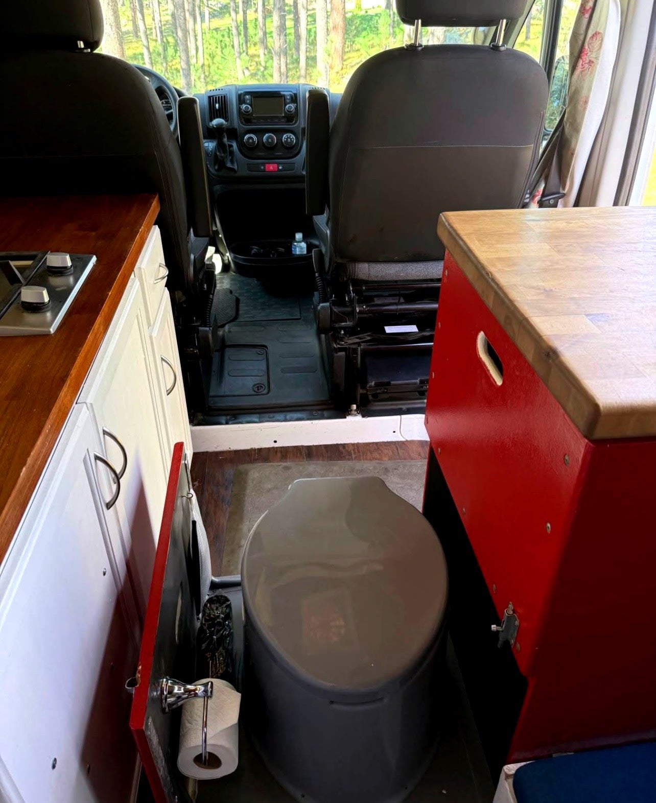perfect for outdoor gear.|Custom rv rental interior: compact kitchen with light blue microwave