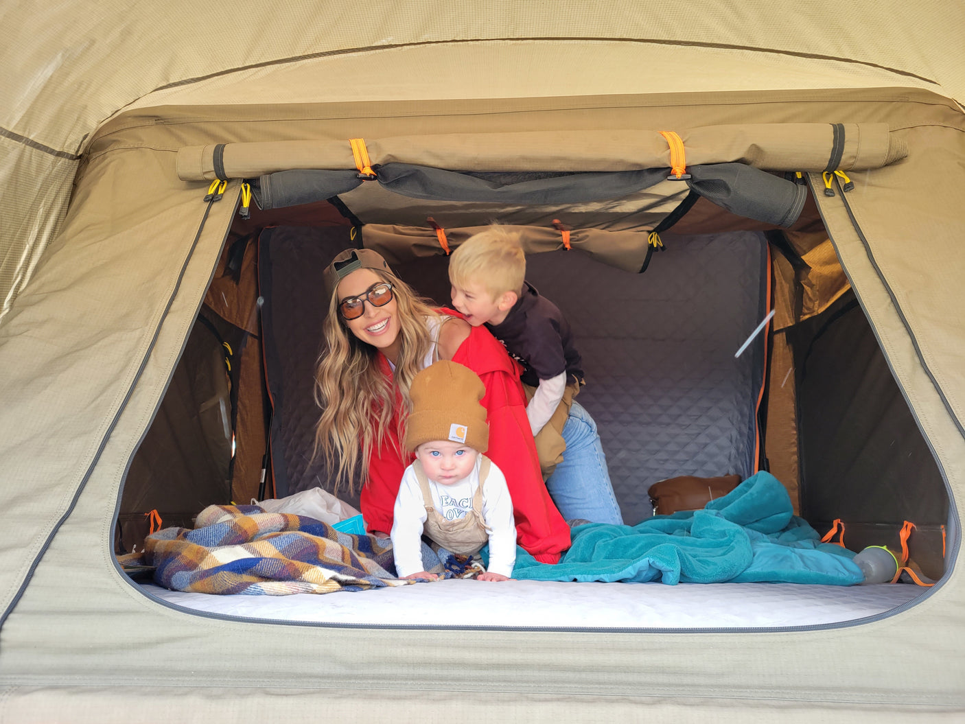Family fun inside a comfortable tent. An RV rental adventure creating happy memories for mom, toddler, and baby.