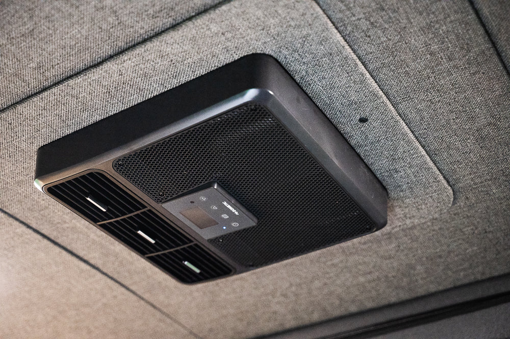 Overhead Dometic AC unit in an RV rental, showing vents and a control panel for precise climate comfort.