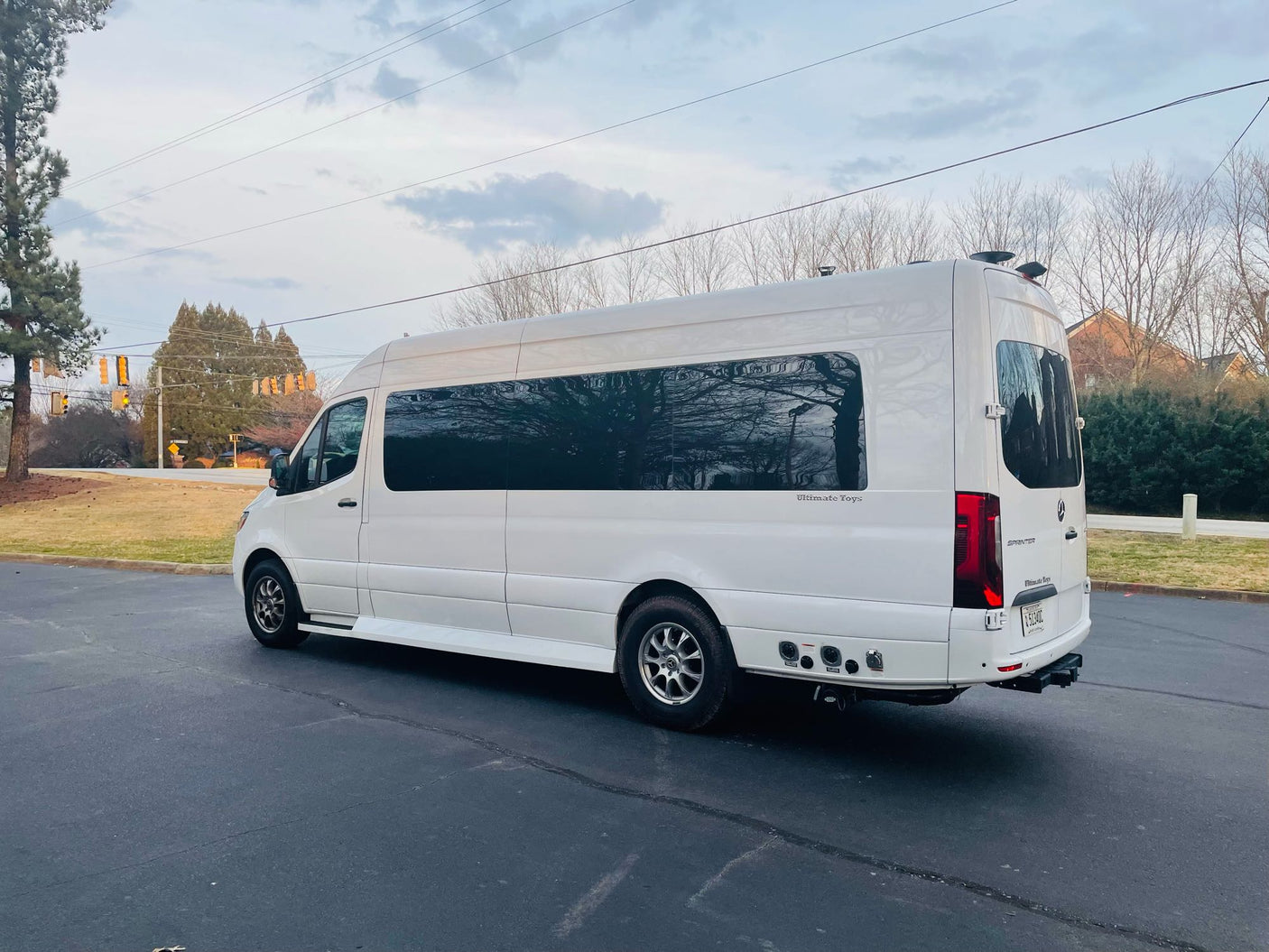 Explore in style! This customized white Mercedes Sprinter van, an "Ultimate Toys" luxury RV rental, is ready for adventure.
