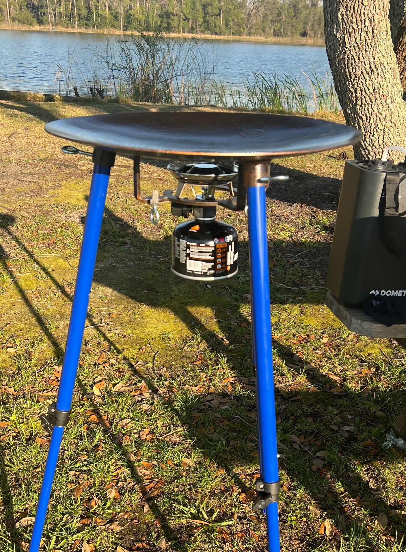 Enjoy outdoor cooking with this portable grill and Dometic cooler, perfect for your RV rental adventure by the lake.