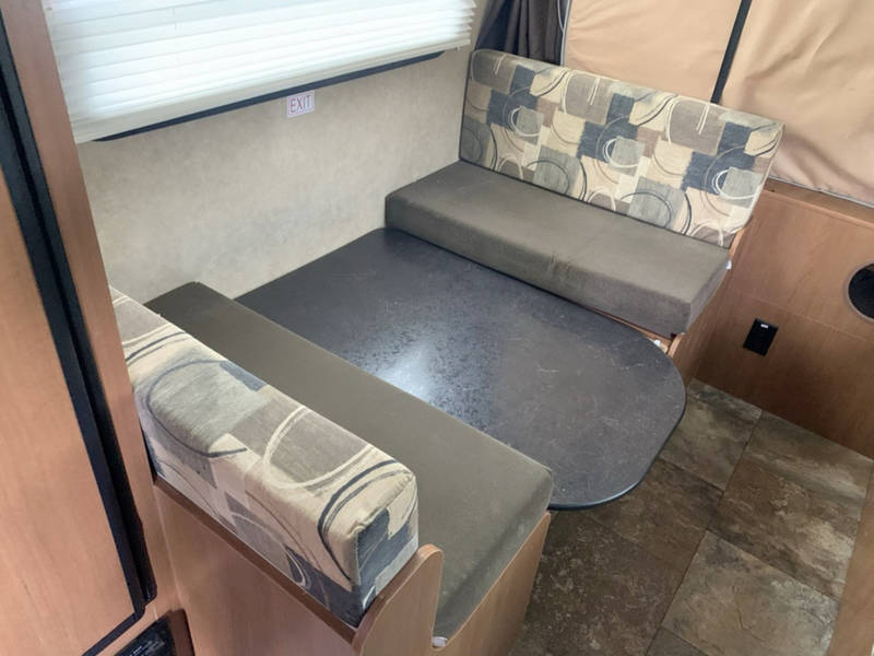 and convenient under-sink storage.|Inside an RV rental pop-up camper: a quilted bed and fabric walls provide a cozy sleeping area.|White StarCraft Launch travel trailer RV rental — photo 20
