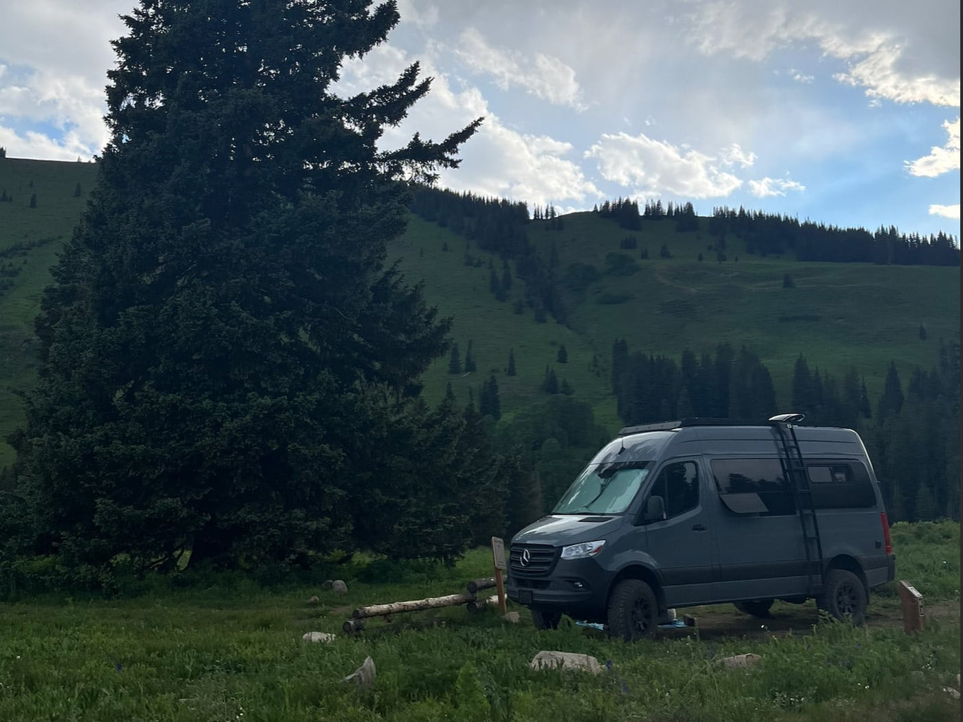 and a window overlooking a forest.|Cozy RV rental interior with a comfortable bed — photo 12