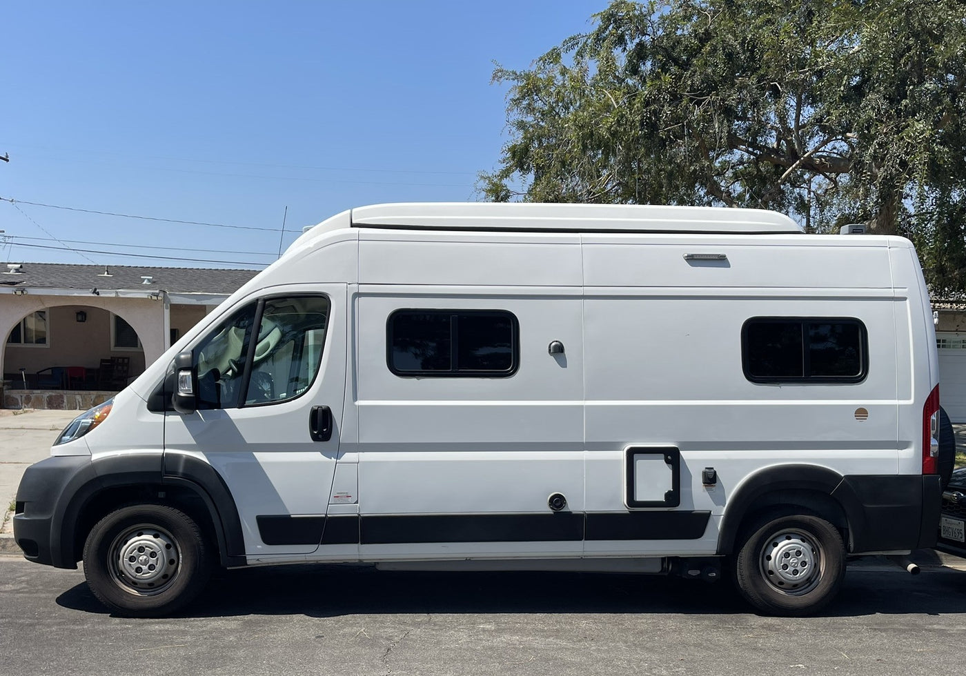 perfect for your next RV rental adventure.|Bright white Ram ProMaster camper van — photo 8