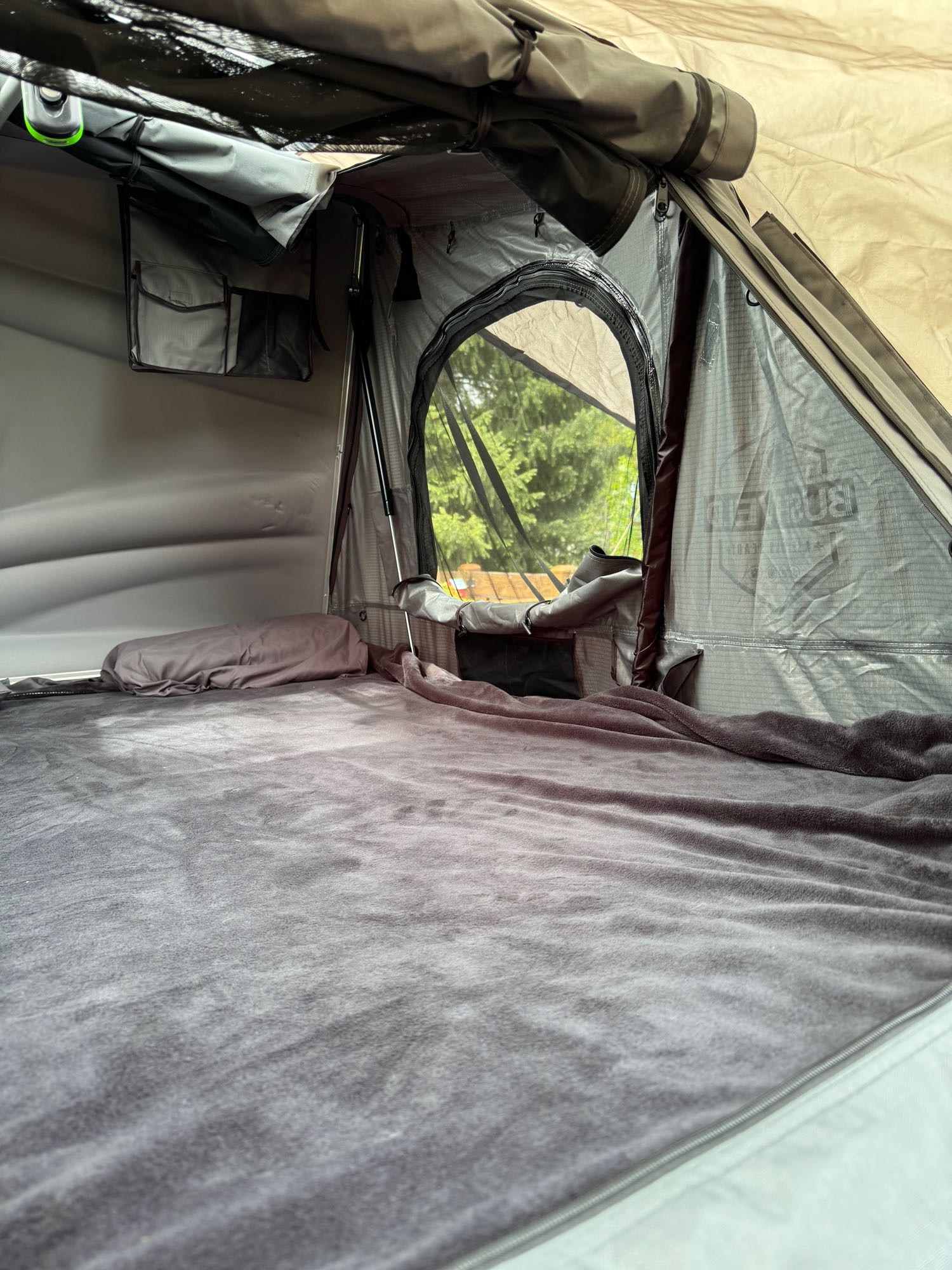 & storage. Ideal for an RV rental camping adventure.|View from an RV rental showing two people camping in a forest