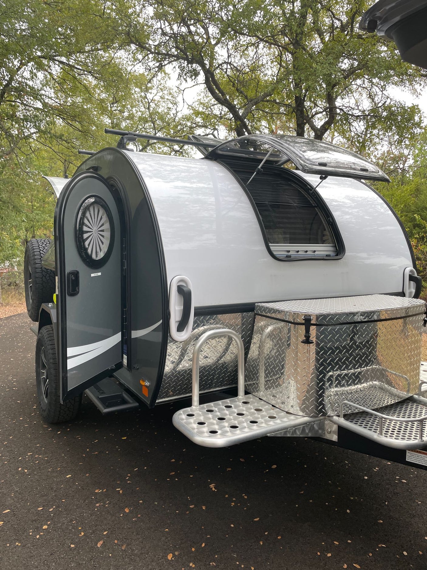fridge for camping adventures.|Fresh coffee brewing in a blue Moka pot on a stove in a compact rv rental kitchen