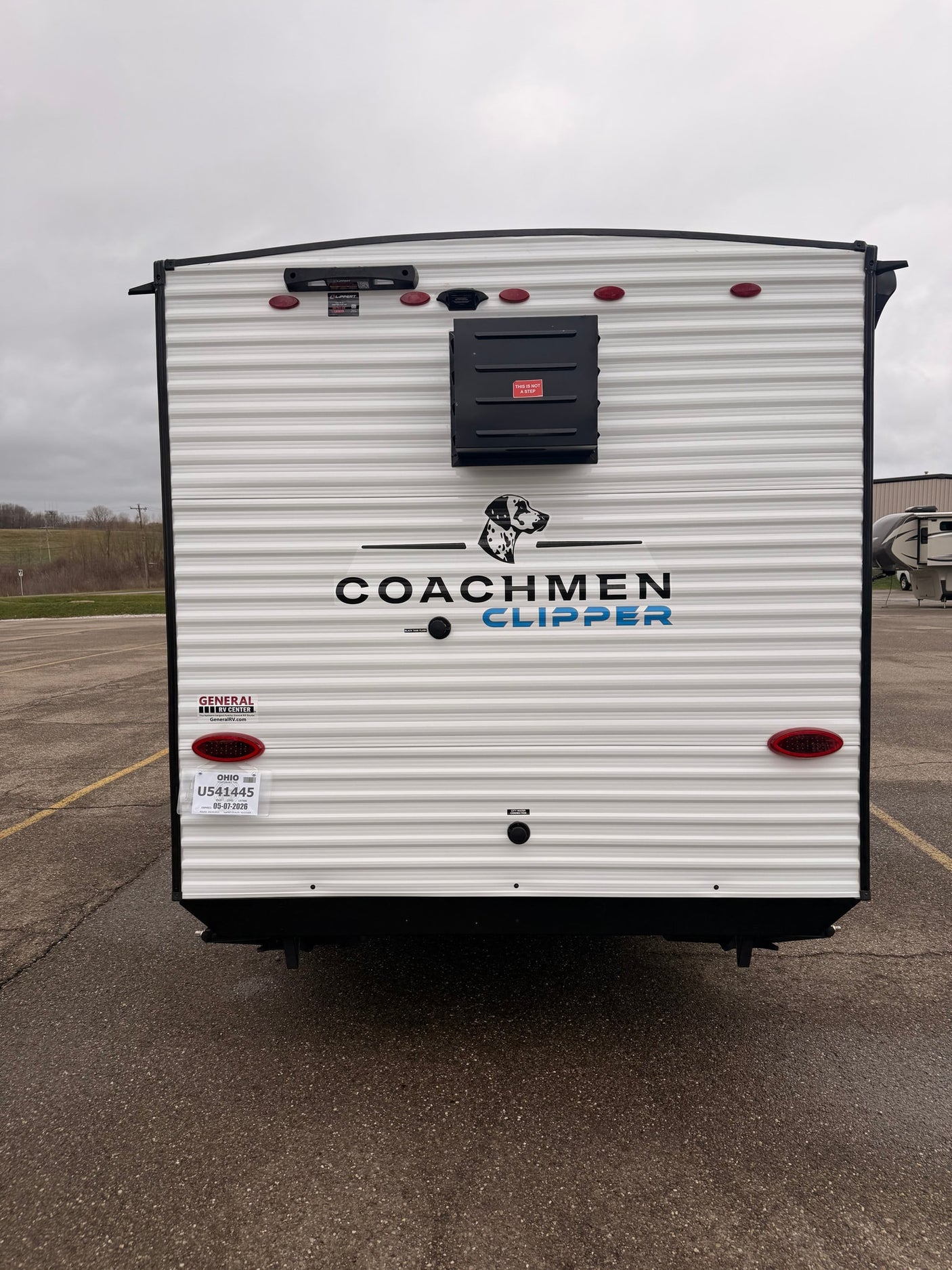Rear view of a Coachmen Clipper travel trailer rv rental, with Ohio license and "General RV Center" decal, ready for your trip.