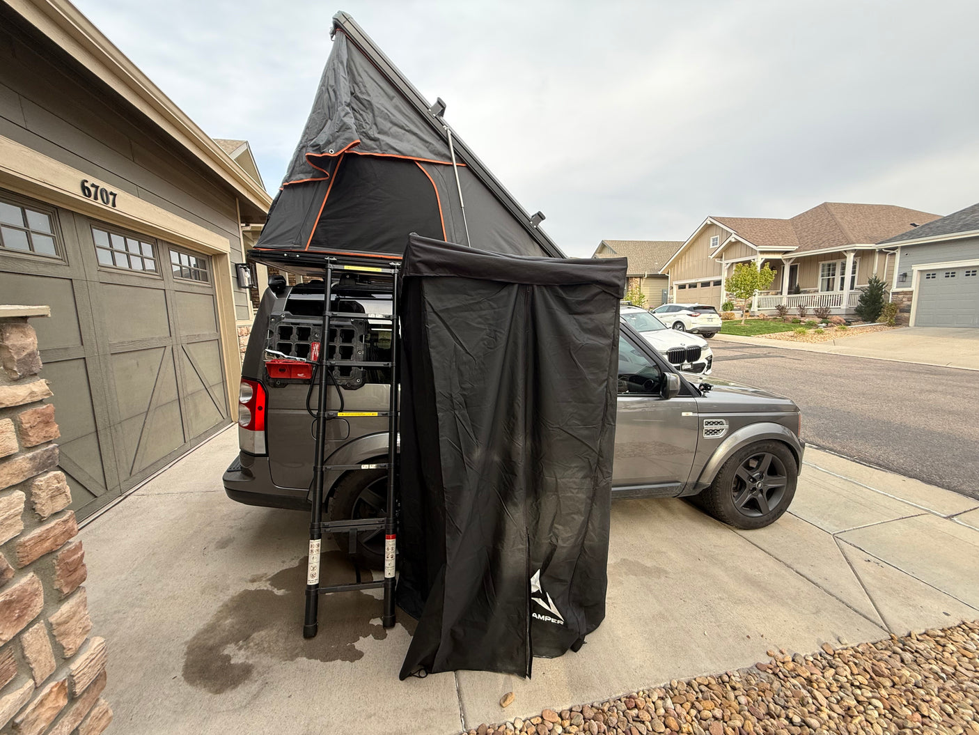 Explore with this rv rental featuring an overland SUV, deployed iKamper rooftop tent, and privacy room, ready for your next outdoor adventure.