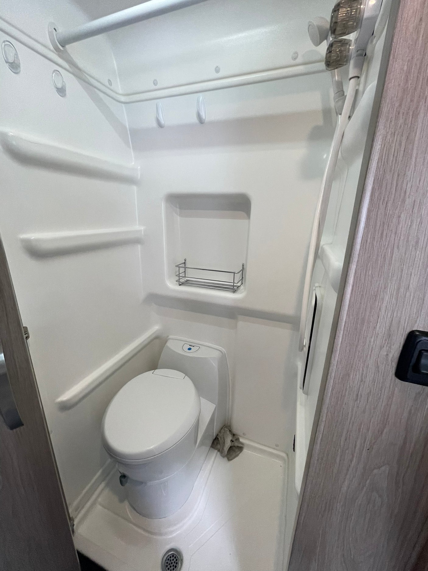 Compact RV rental wet bath with integrated toilet and shower, optimized for small spaces and travel.