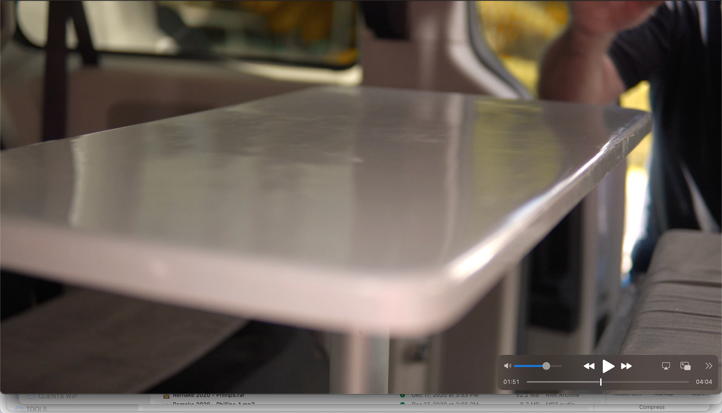 RV rental interior with a portable table for on-the-go workspace or dining, shown during video playback.