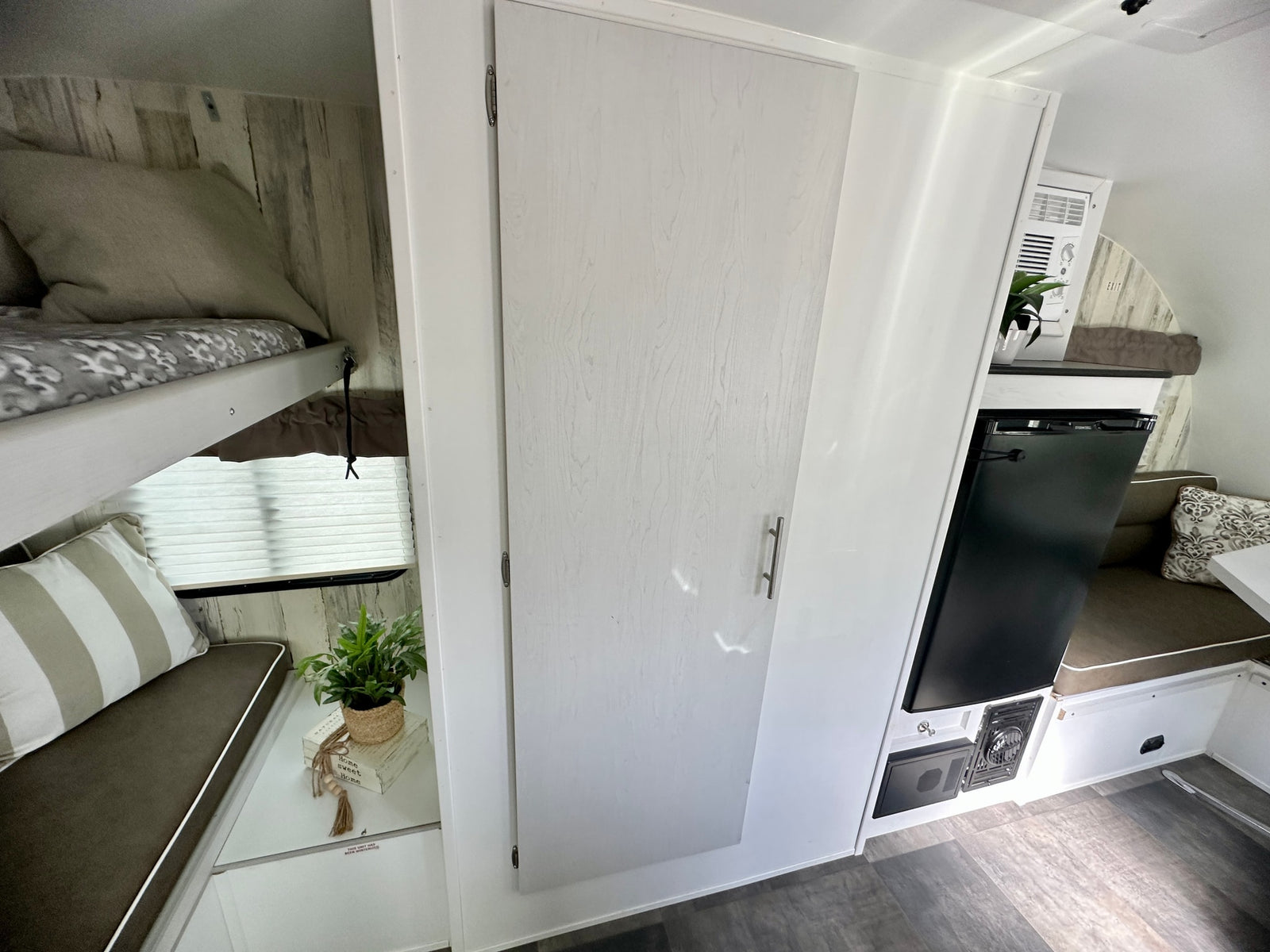 and overhead storage.|Bright RV rental interior showing a compact kitchen with stove
