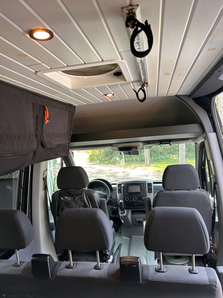 and trash bin.|Functional RV rental interior: wood-top kitchen with sink — photo 13