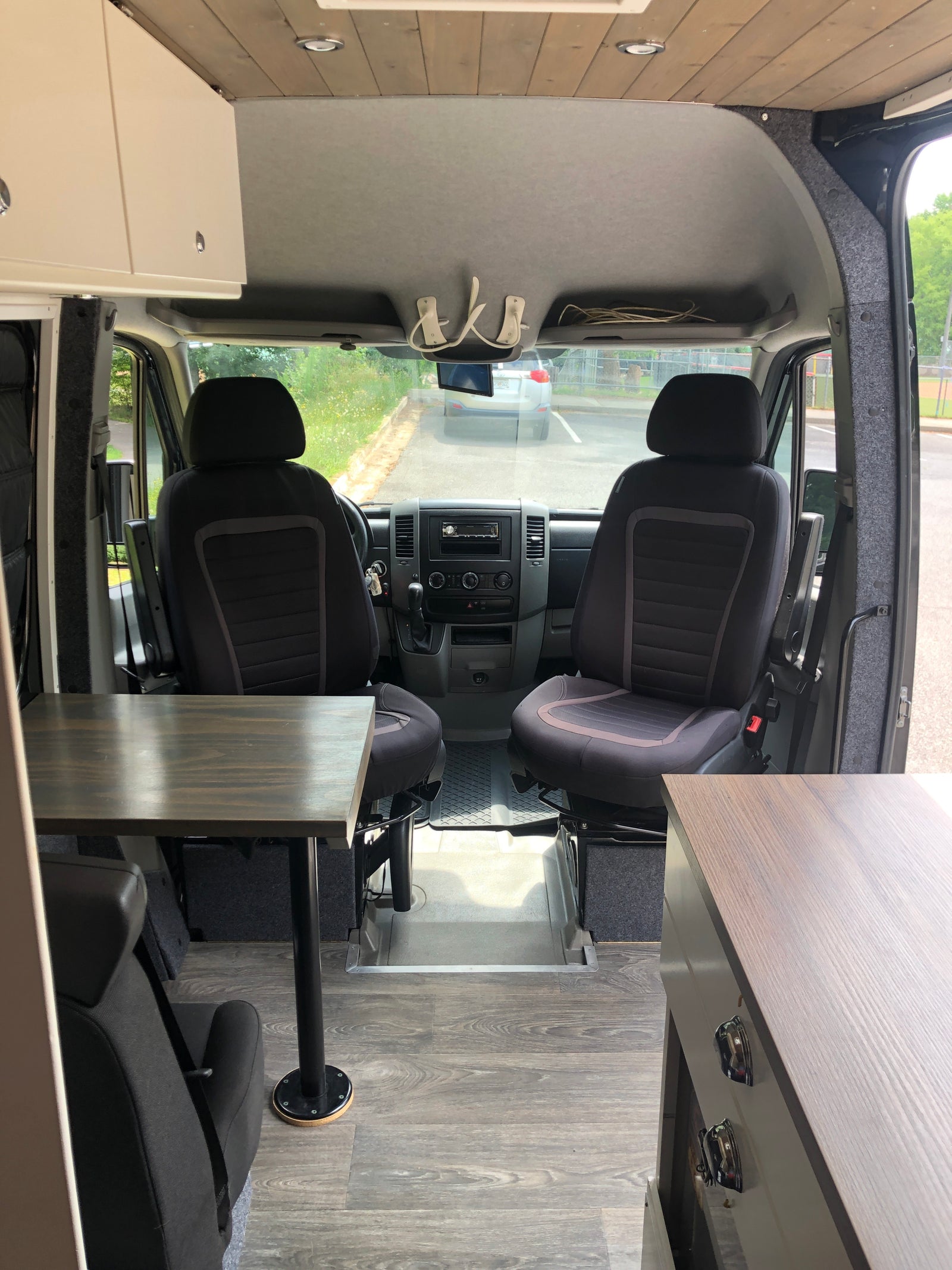 and birch tree wall decor.|Cozy RV rental camper interior: wooden counter with sink & faucet