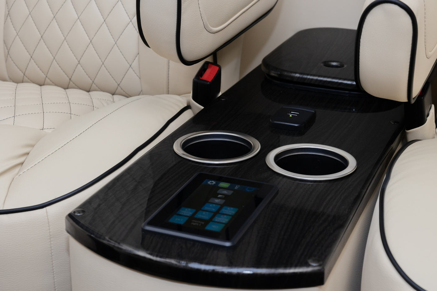 and custom amenities for comfort.|Spacious luxury RV rental interior featuring plush cream quilted leather seating