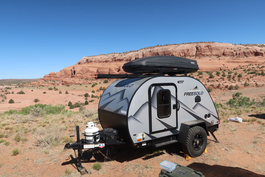 A gray teardrop camper