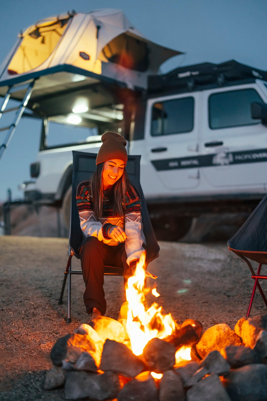 ideal for an RV rental adventure.|Smiling woman in a Tepui rooftop tent on a Jeep Gladiator. Discover overlanding adventure with an RV rental.|This RV rental's organized rear setup features a fridge