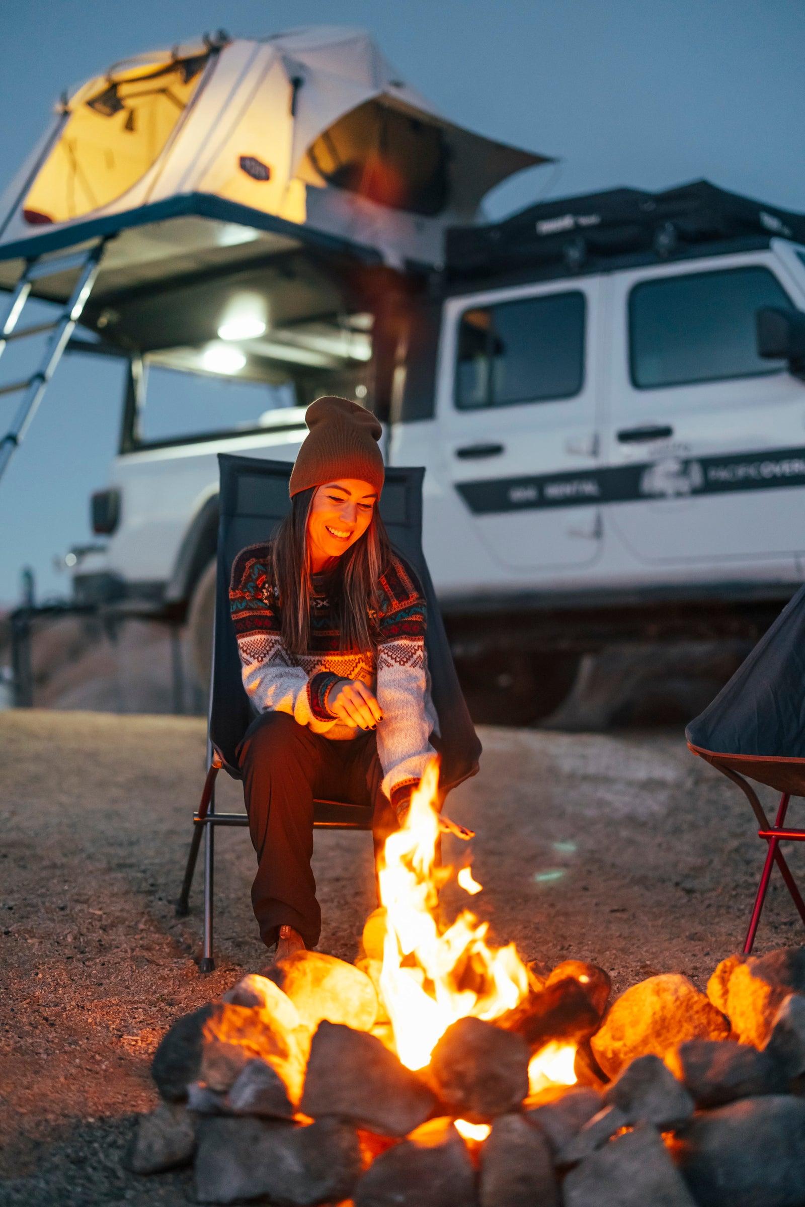 ideal for an RV rental adventure.|Smiling woman in a Tepui rooftop tent on a Jeep Gladiator. Discover overlanding adventure with an RV rental.|This RV rental's organized rear setup features a fridge