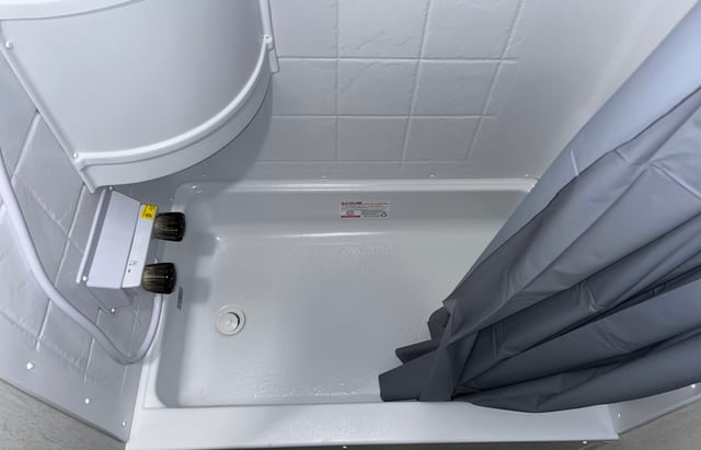 & black siding visible.|This RV rental's utility panel features a water heater access